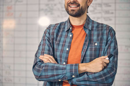 Bearded young man holding marker pen and smilingの写真素材
