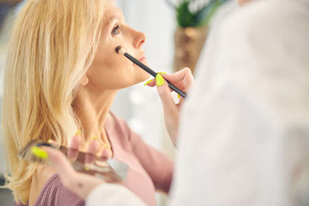Relaxed longhaired female sitting in semi positionの写真素材