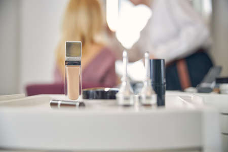 Close up of face foundation being near lipstickの写真素材