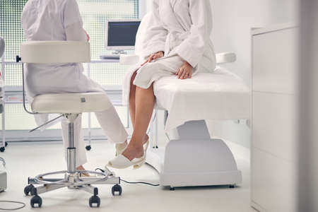 Close up of females sitting opposite each otherの写真素材