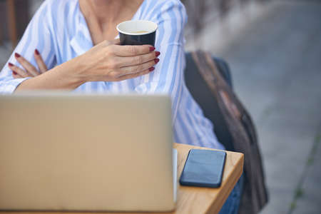 Caucasian female sitting in front of the laptop