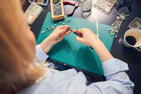 Delicate work of professional jeweler in room