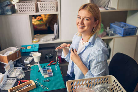 Smiling Caucasian woman working in bijouterie studioの写真素材