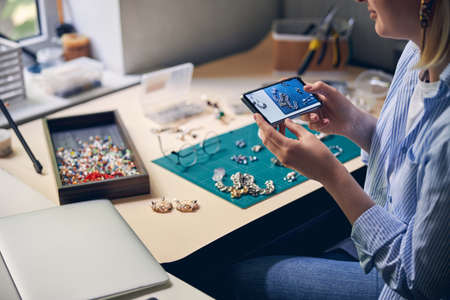 Bijouterie speciaist taking a picture of working table