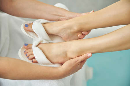 Female legs in hands of beauty artistの写真素材