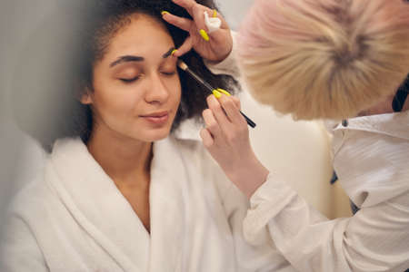 Skilled beauty specialist during working hours in salonの写真素材