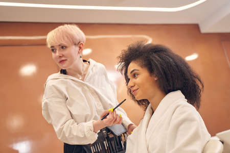 Makeup artist during working process in beauty parlor