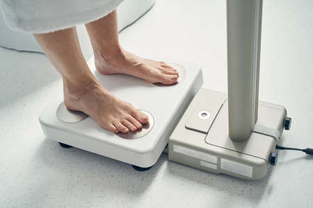 Two legs of adult female on multifunctional medical apparatusの写真素材