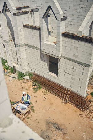 Senior engineer sitting at a construction site