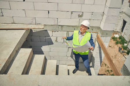 Senior male looking at a construction object