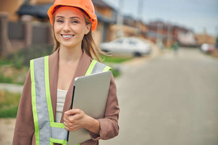 Woman with a computer posing for the camera