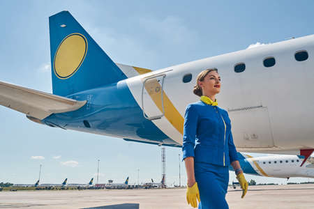 Serene Caucasian stewardess looking into the distance