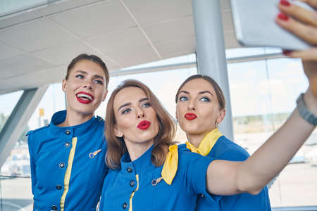 Beautiful stewardesses posing together for the cameraの写真素材