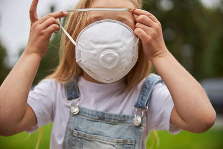 Cute female child wearing protective mask on face