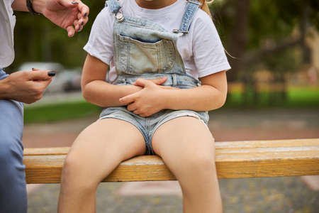 Female child resting in the outdoors with womanの写真素材