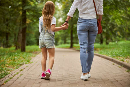Female with little girl enjoying good warm weather in the outdoorsの写真素材