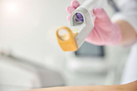 Professional female dermatologist performing a beauty procedure