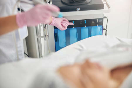 Doctor in gloves preparing for a cosmetic procedure