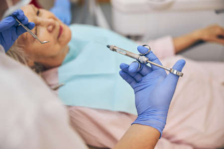 Injection with anesthesia performed by man doctor