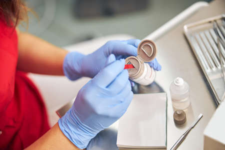 Top view of female dentist is preparing the equipment