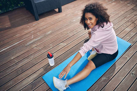 Brunette woman with curly hair enjoying sport
