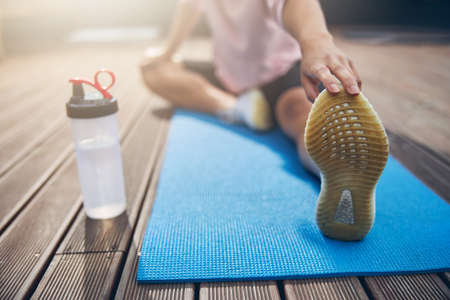 Female spending time outside on yoga mat