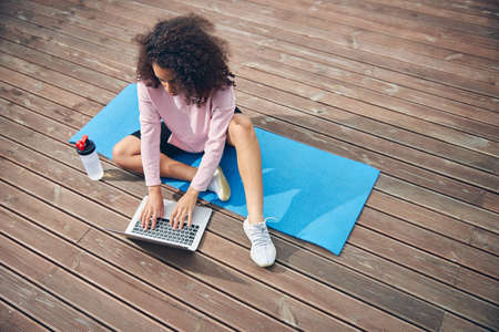 Woman with curly hair using computer for work