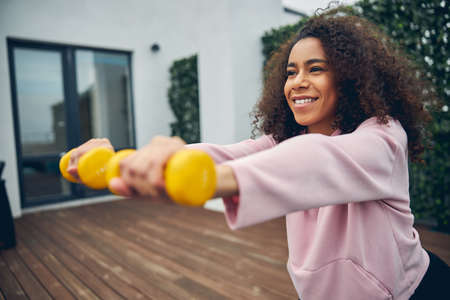 Beautiful woman with curly dark hair trainingの写真素材