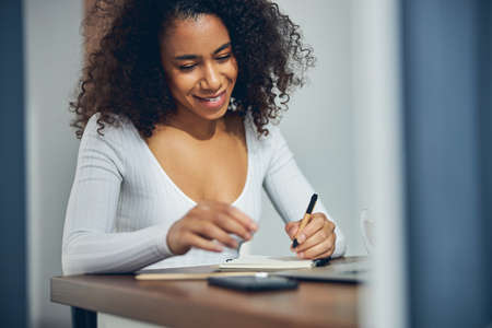 Beautiful young lady spending time working alone