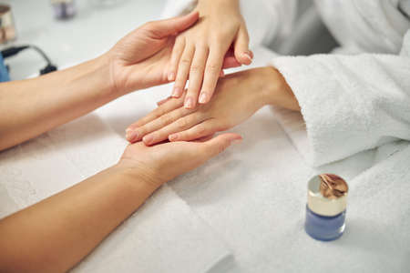 Woman visiting spa salon for natural manicureの写真素材