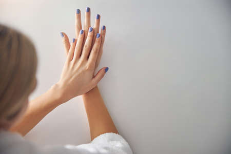 Female rejoicing at new beautiful finished manicureの写真素材