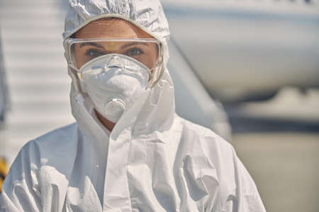 Woman wearing safety goggles and a maskの写真素材