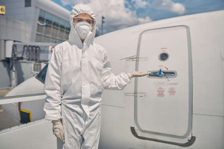 Woman standing in front of the aircraft entranceの写真素材