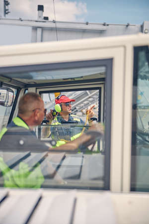 Truck driver looking at his male colleague