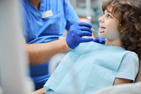 Cheerful kid smiling during a dental check-up