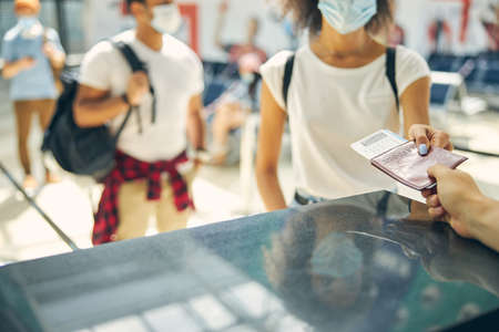 Female is taking document on passport controlling
