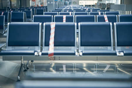 Contemporary airport waiting area with protection tape on chair