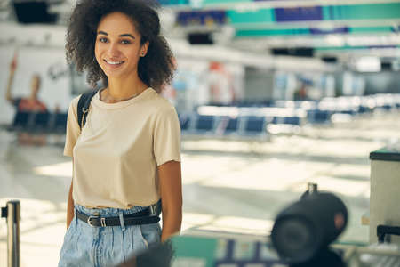 Good looking young African woman standing in the airport
