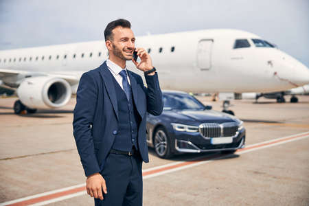 Businessman standing in front of an aircraft