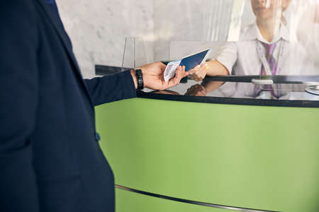 Traveler getting passport and flight tickets back after a check