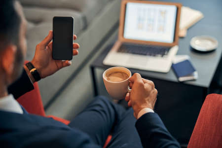Smartphone in hand of businessman copy space photo