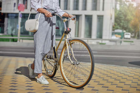 Female tourist walking in the famous place of city with bike