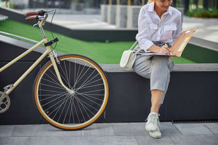 Business lady looking through the documents in the outdoors