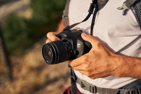 Man using digital camera in open air