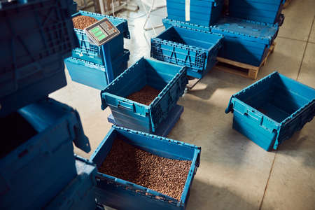 Plastic container with coffee beans on scalesの写真素材
