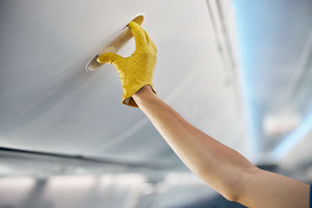 Beautiful female arm open the luggage compartmentの写真素材