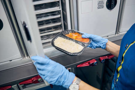 Focused image of woman hands holding meal in boxの写真素材