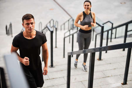 Athletic male going jogging with girlfriend outdoorsの写真素材