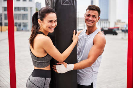 Happy young couple during boxing training outdoorsの写真素材