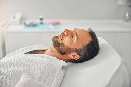 Handsome young man resting in cosmetological clinic